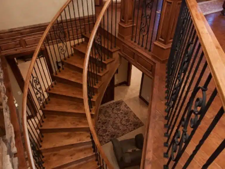 curved wooden stair and metal railing